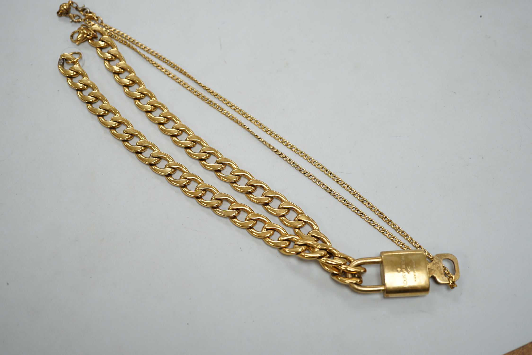 A Louis Vuitton gilt metal key and padlock pendant, 36mm, on a Boutique Secondlife of London, curb link chain, chain 40cm.